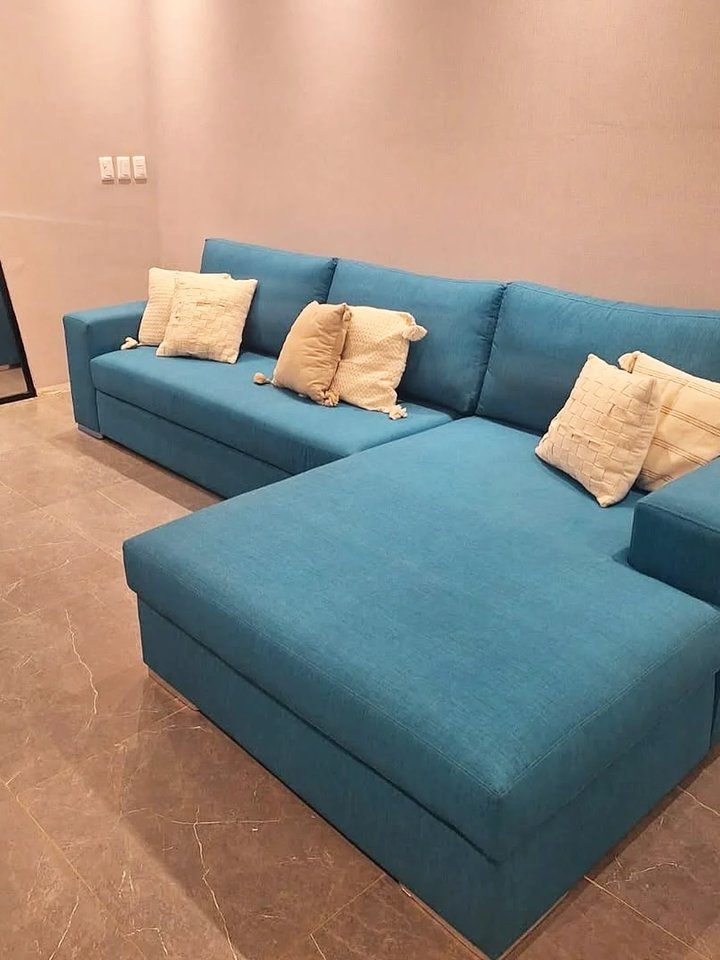 Sofá estofado azul petróleo em sala de estar